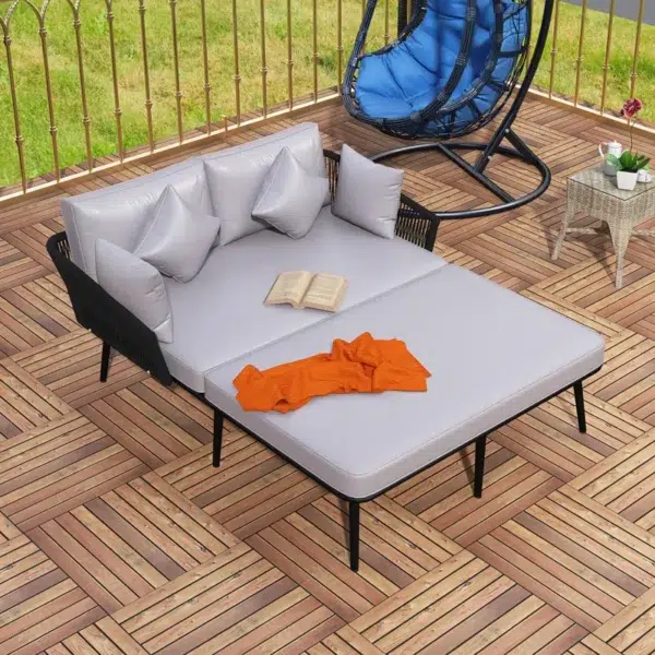 Outdoor patio daybed with black woven nylon rope backrest and light grey washable cushion