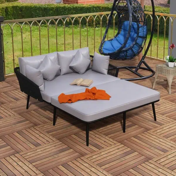 Outdoor patio daybed with black woven nylon rope backrest and light grey washable cushion