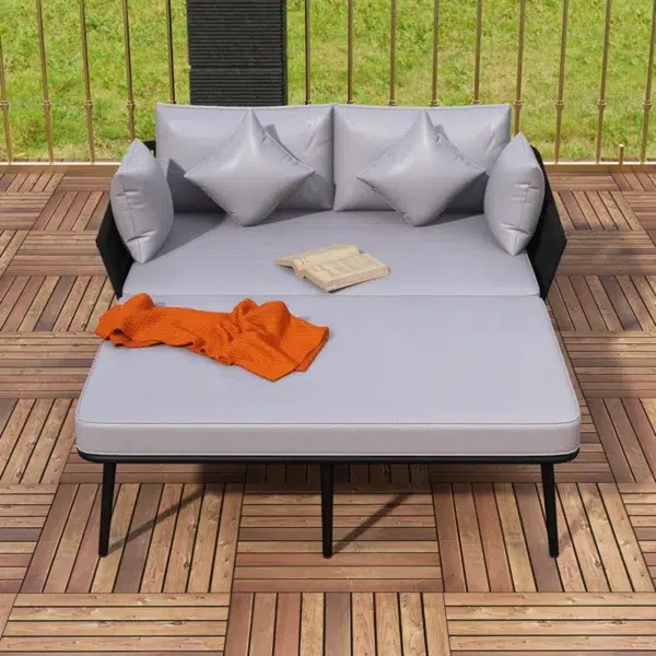 Outdoor patio daybed with black woven nylon rope backrest and light grey washable cushion