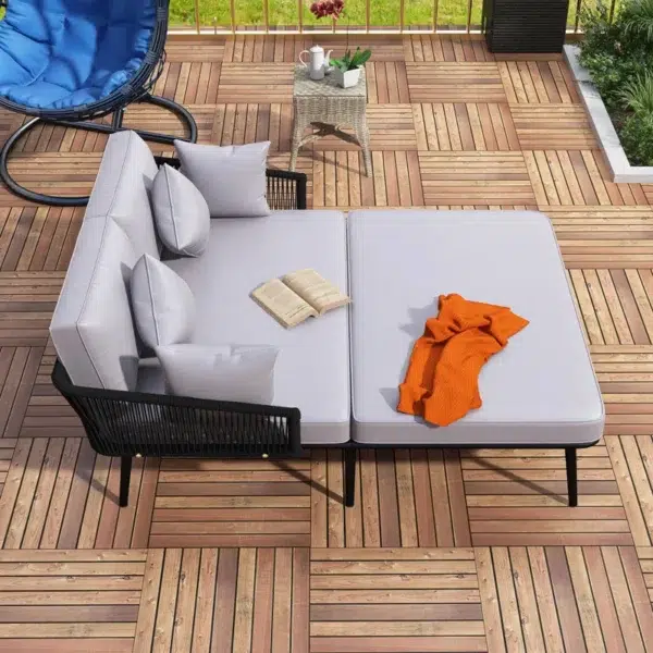 Outdoor patio daybed with black woven nylon rope backrest and light grey washable cushion