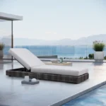 Outdoor rattan wicker chaise lounge chair in black and grey with adjustable reclining design.