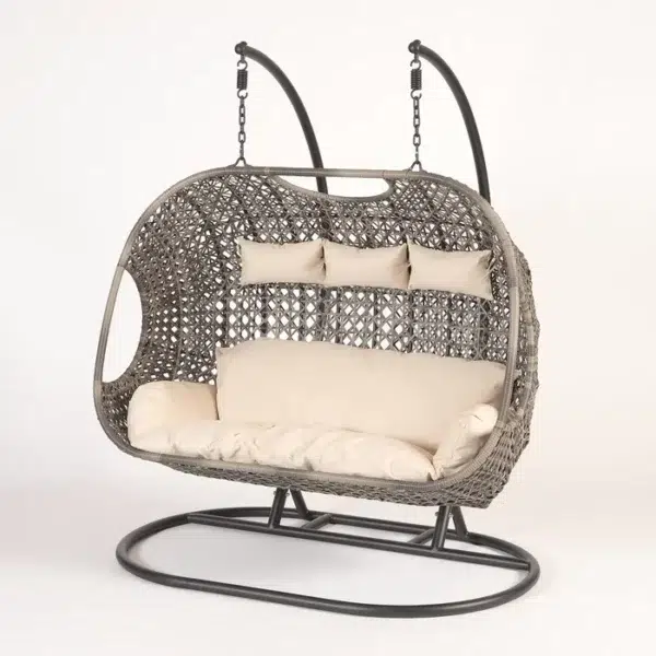 Three-seater hanging swing with sturdy stand in dark brown frame and cream cushions, perfect for balcony or garden relaxation.