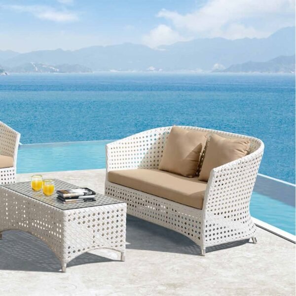 Outdoor 4-seater sofa set with white and beige cushions, placed in a garden setting for relaxation.