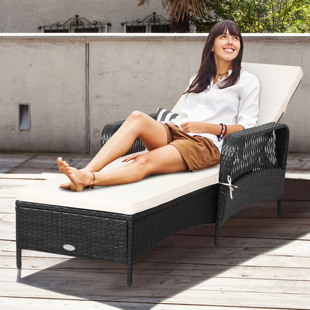 Adjustable outdoor chaise lounge chair in black wicker with off-white cushion