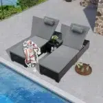 Set of 2 dark grey wicker rattan outdoor chaise lounge chairs with matching table for patio or garden.