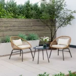 "3-piece outdoor wicker patio set with a sofa, two chairs, and a coffee table in a natural rattan finish."
