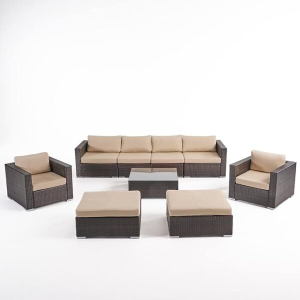 4-piece outdoor patio furniture set with rattan sofa, cushioned chairs, and coffee table in a garden setting"