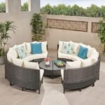 Outdoor rattan wicker full moon sofa set with cushions on a garden patio