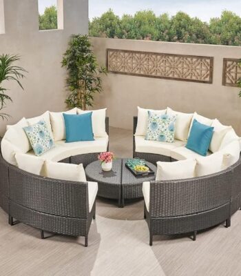 Outdoor rattan wicker full moon sofa set with cushions on a garden patio