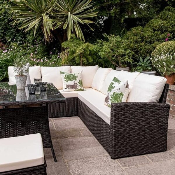 Outdoor rattan wicker patio sofa set with beige cushions and matching center table in garden setting