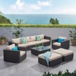 4-piece outdoor patio furniture set with rattan sofa, cushioned chairs, and coffee table in a garden setting"