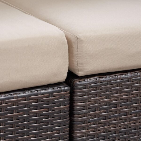 "4-piece outdoor patio furniture set with rattan sofa, cushioned chairs, and coffee table in a garden setting"
