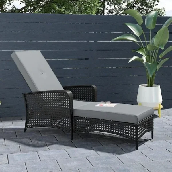 Adjustable outdoor chaise lounge chair in black wicker with off-white cushion