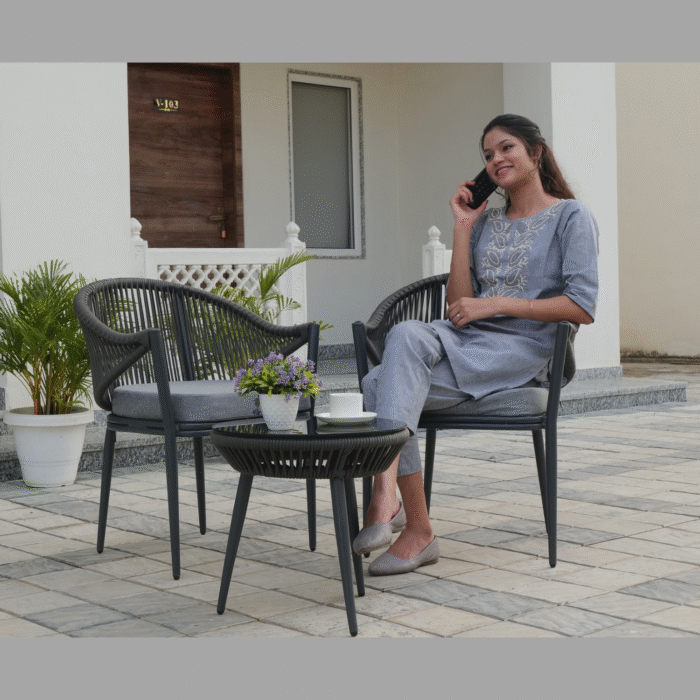 Outdoor rope lounge chair with matching glass-top coffee table, weather-resistant and cushioned