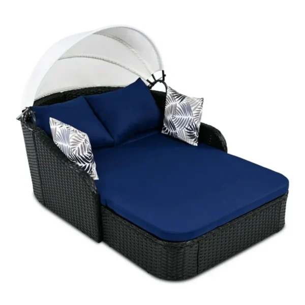Outdoor rattan wicker double seater canopy daybed with cushions for patio and garden relaxation.