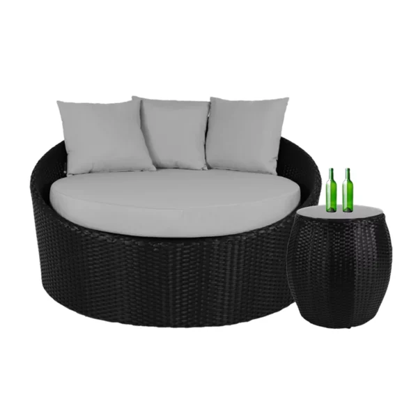 Outdoor rattan wicker daybed with plush cushions and matching glass top table for patio lounging