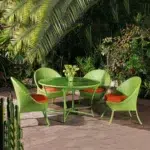 Outdoor all-weather resistant rattan wicker 5-piece dining set with table and chairs for patio or garden use.