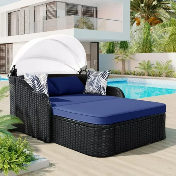 Outdoor rattan wicker double seater canopy daybed with cushions for patio and garden relaxation.