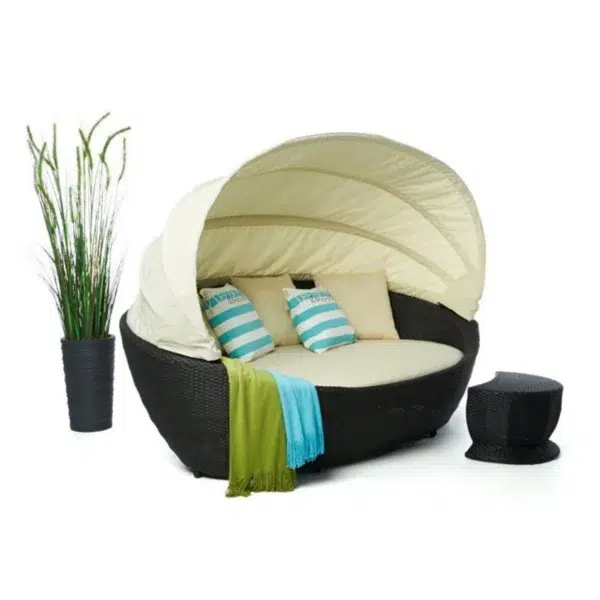 Luxury outdoor wicker patio daybed with retractable canopy for all-weather comfort.