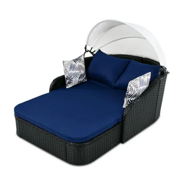 Outdoor rattan wicker double seater canopy daybed with cushions for patio and garden relaxation.