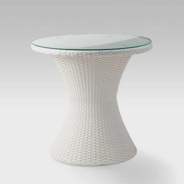White 3-piece rattan wicker patio set with two chairs and a glass-top table on a balcony overlooking the sea.