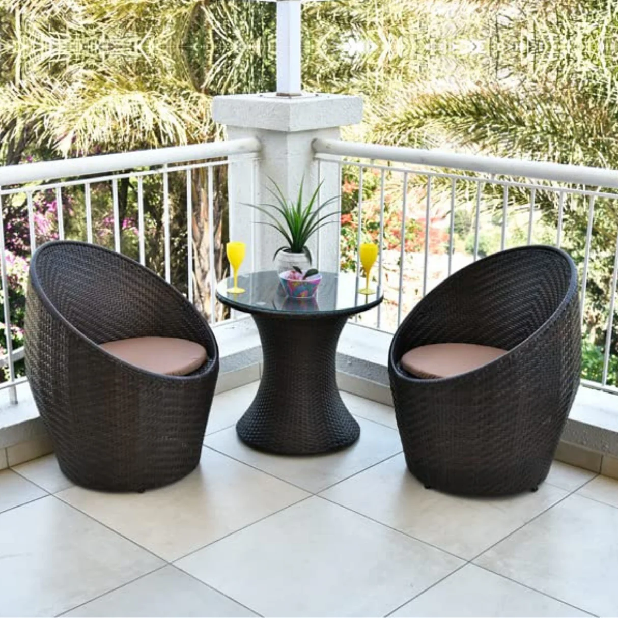 Modern 3-piece outdoor rattan wicker conversation set with two cushioned chairs and a matching glass-top table