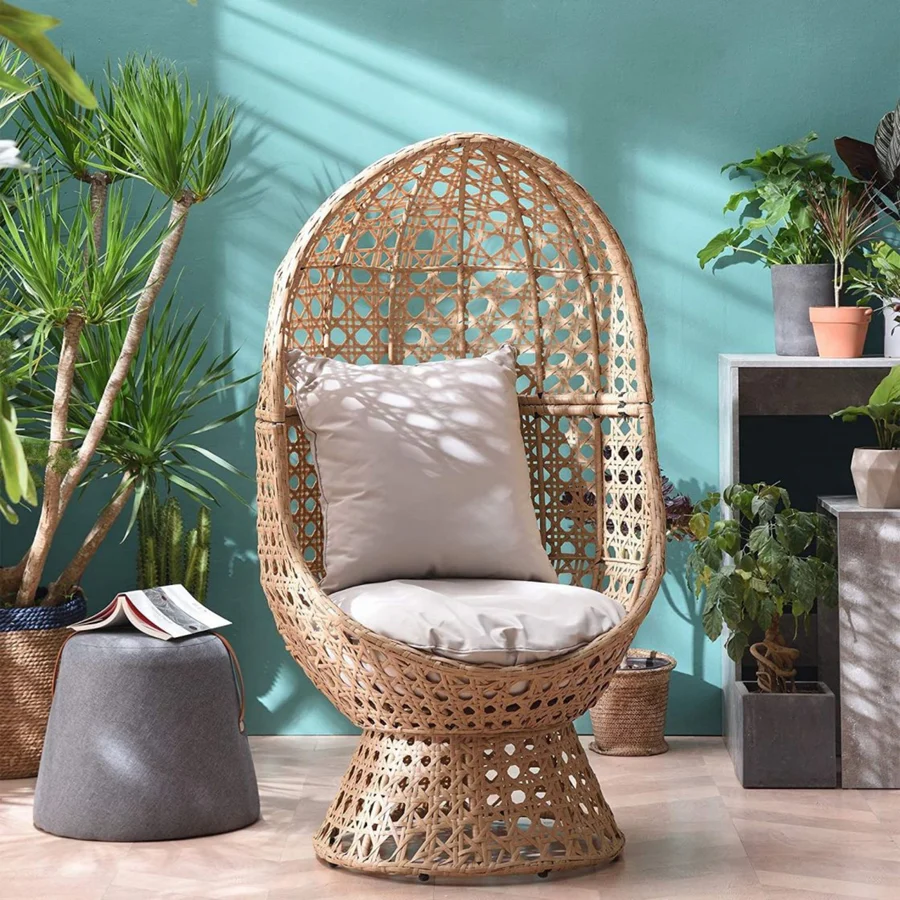 Beige rattan wicker cocoon chair with a comfortable cushion for outdoor patio or garden