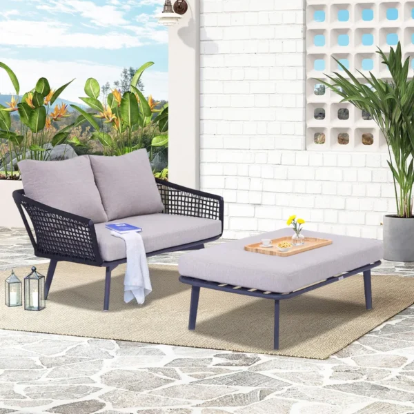 2-piece outdoor rope loveseat sofa with matching ottoman on a patio, featuring weather-resistant cushions