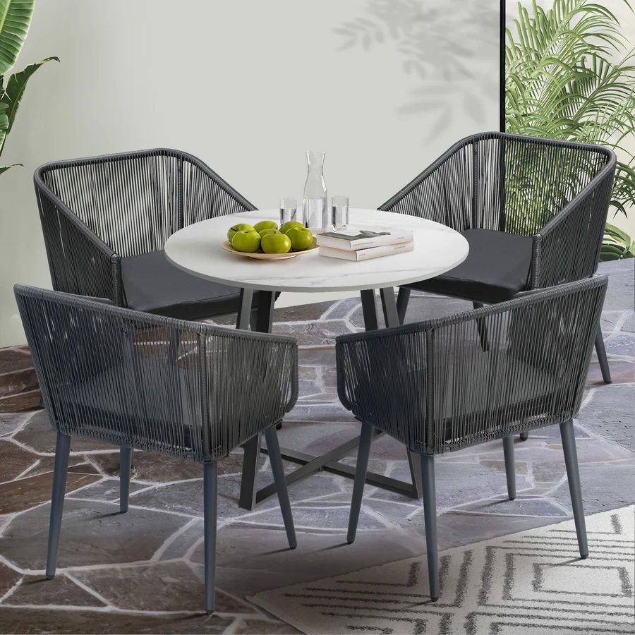Alt Text: 5-piece outdoor patio dining set with rope chairs and marble-top table on a terrace