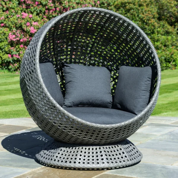 Single seater outdoor basket swing hanging on balcony with cozy cushions