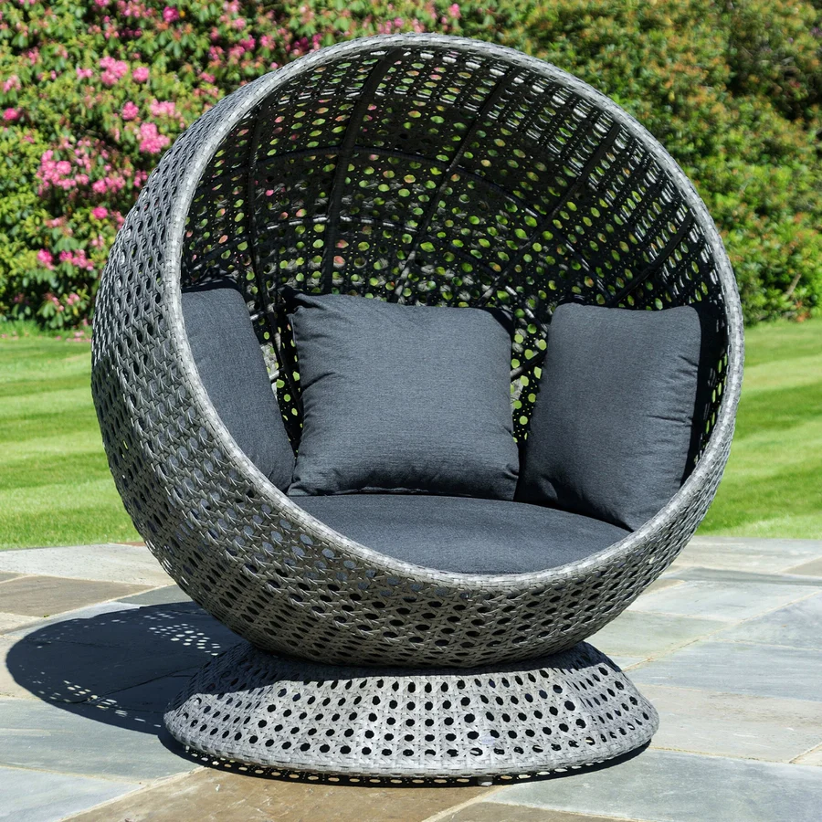Single seater outdoor basket swing hanging on balcony with cozy cushions