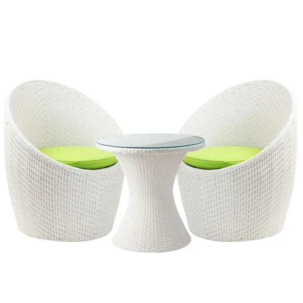 White 3-piece rattan wicker patio set with two chairs and a glass-top table on a balcony overlooking the sea.