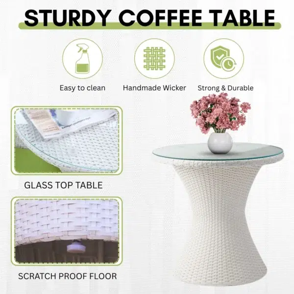 White 3-piece rattan wicker patio set with two chairs and a glass-top table on a balcony overlooking the sea.