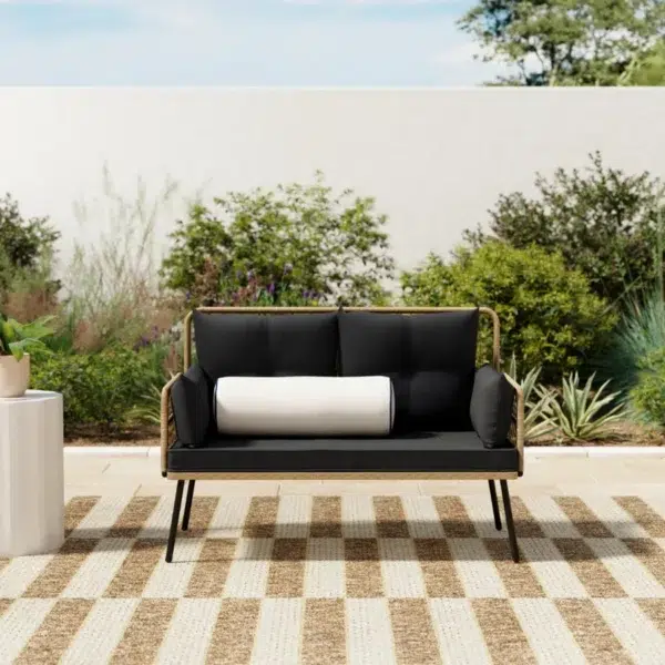 “Stylish outdoor rattan wicker loveseat sofa with soft beige cushions on a patio setup”