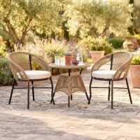 Loccus 2 Seater Outdoor Patio Furniture Set with Two Rope Woven Chairs, Cream Cushions and Round Table in a Garden Setting
