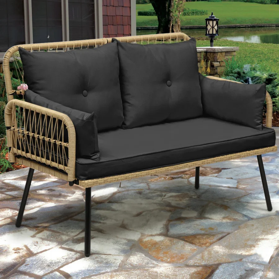 “Stylish outdoor rattan wicker loveseat sofa with soft beige cushions on a patio setup”